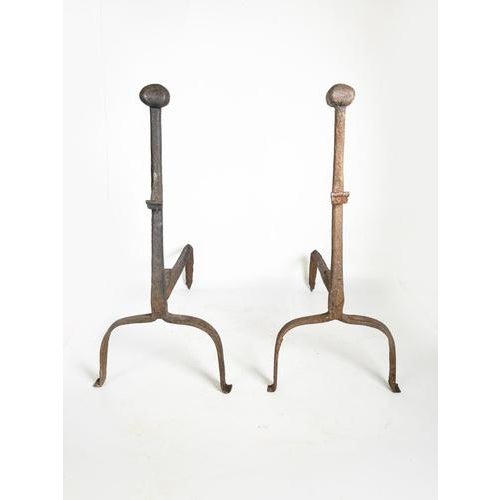 Pair of cast iron andirons, France, 1960s, with a simple and authentic design. These robust pieces feature a clean, forged...