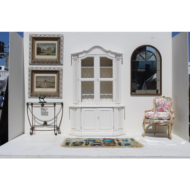 Rare Venetian arched wall accent mirror with brass painted wood frame and windowpane details. The beveled mirror insets in...