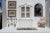 Rare Venetian arched wall accent mirror with brass painted wood frame and windowpane details. The beveled mirror insets in...