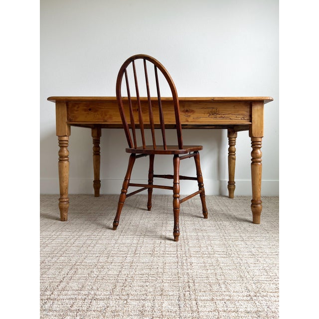 This antique, c. late 1800s English primitive pine table is a remarkable example of Victorian period craftsmanship,...