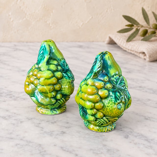 A charming vintage pair of INARCO ceramic salt and pepper shakers, model E2604. Each pear-shaped shaker is richly...