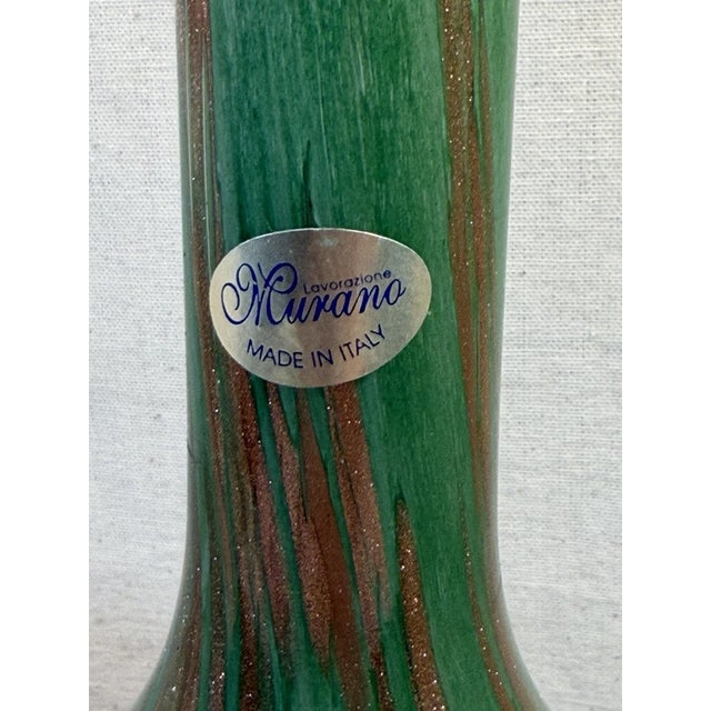 This elegant piece features a rich emerald green base beautifully enhanced with copper aventurine, a classic Murano...