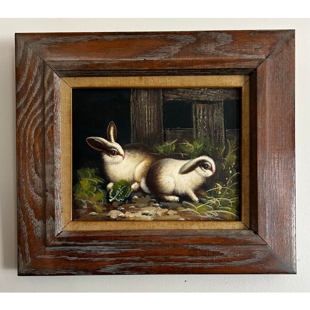 Vintage oil painting of two rabbits in vintage wood frame. Painting measures 8 x 10”.