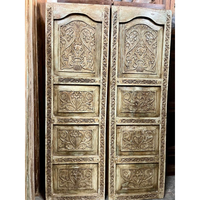 Make an unforgettable architectural statement with this vintage hand-carved wooden double door, richly adorned with...