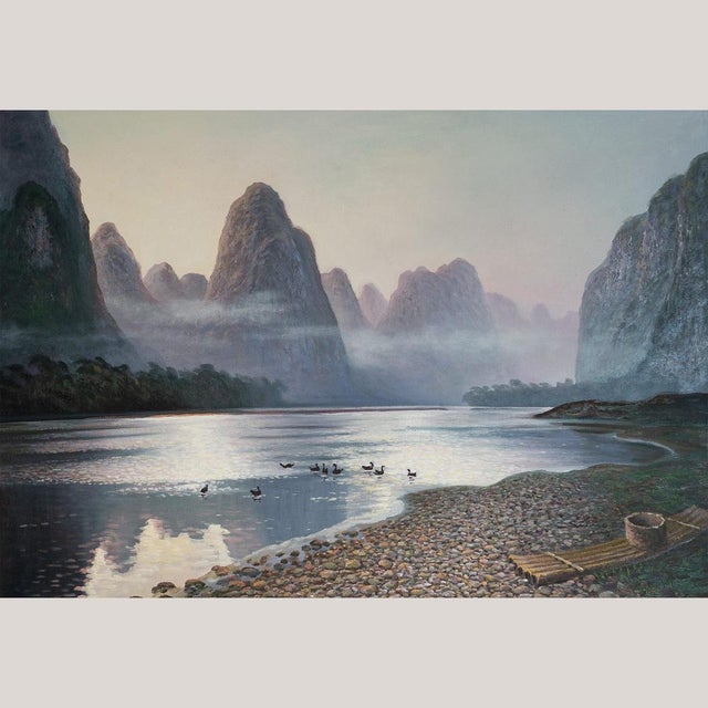 Tranquil Dawn on the Li River is a captivating oil on canvas that evokes the ethereal stillness of dawn along China’s...