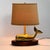 Vintage 1970s brass whale table lamp with a substantial sculptural whale form mounted on an oval wood base. The whale...