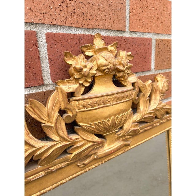 Late 19th century French Louis XVI–style mirror with exquisite gold leaf gilding. Featuring delicate carved details, a...
