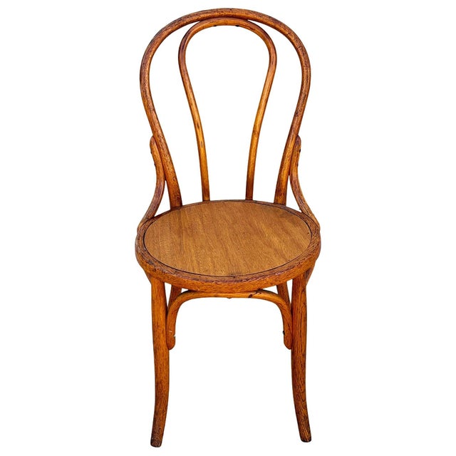 The Victorian Thonet number 7 side chair features an elegant, sculptural frame crafted from warm-toned bentwood with...