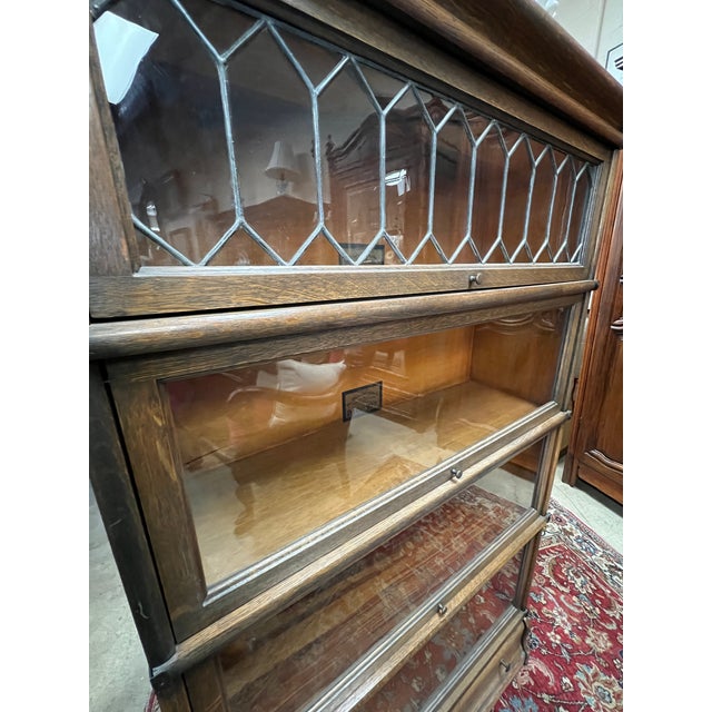 Antique barrister 4 stack bookcase by The Globe Wernicke Co. Cincinnati. Features include: - Leaded glass on top shelf -...