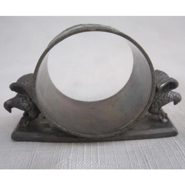 Victorian Silver Metal napkin ring embellished with eagles on both sides. It has a maker's mark on the base and is...