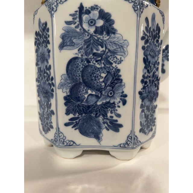 A fabulous hand painted octagonal blue and white teapot made in Thailand in the late 1970’s. Each of the eight sides has a...