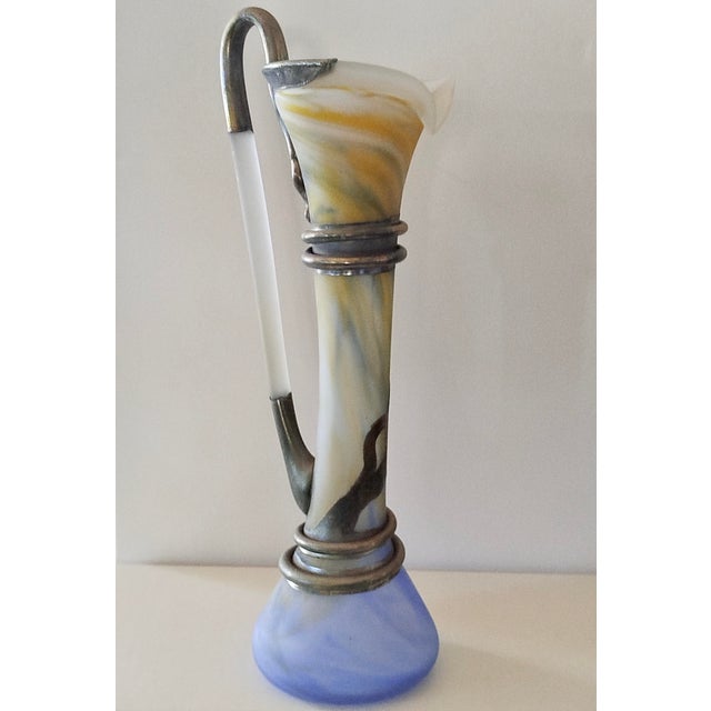 Antique-style carafe-shaped sculptural vase. Entirely handmade, embellished with metal (copper, nickel, brass) applied by...