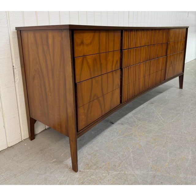 This listing is for a Mid-Century Modern 9-Drawer Walnut Dresser. Featuring a curved front design, nine drawers for...