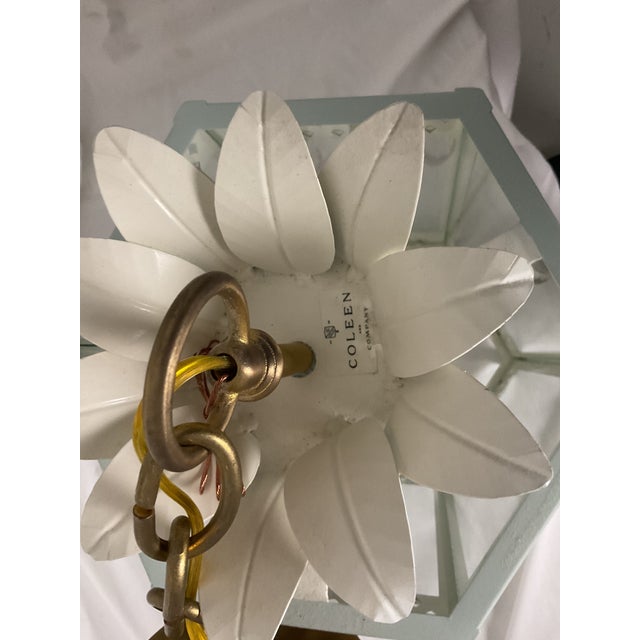 Elegant and architectural, this vintage lantern-style pendant light features a softly painted metal frame in a pale...