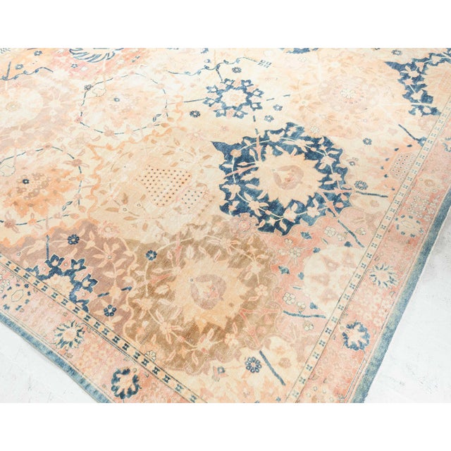 An early 20th century North Indian botanic design carpet with an overall palmette lozenge trellis containing lush floral...