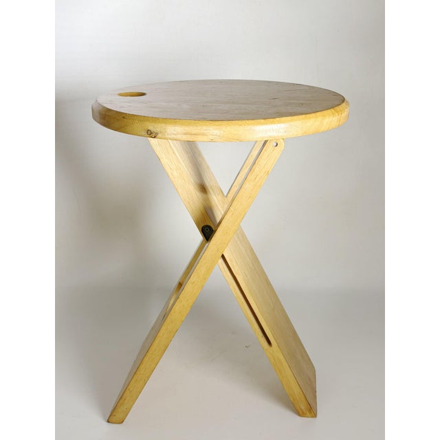Iconic French wooden stool attributed to Roger Tallon, featuring a clever folding construction and a distinctly...