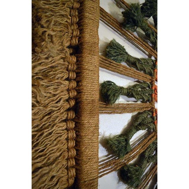This is a vintage macrame wall hanging, made by hand in America. The piece is sized to fill a wall area with the concept...