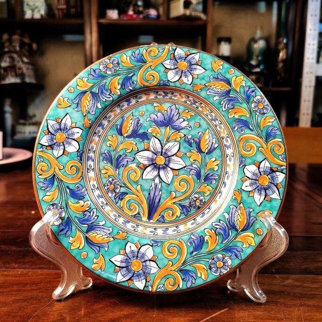 This vintage-inspired plate is crafted from ceramic, featuring a vibrant Majolica-style finish—adorned with hand-painted,...