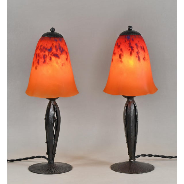 Charles Schneider A wonderful pair of 1925-30 French art deco lamps in wrought iron. The forged bases hold nice colored...