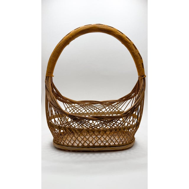 This intricately woven bamboo ikebana flower arrangement basket originates from Japan and features an oblong boat-shaped...