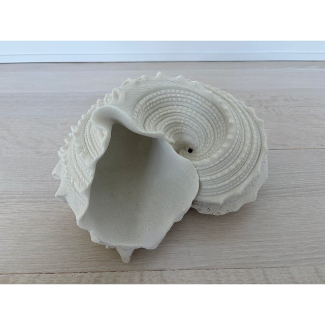 Beautiful large ceramic cast seashell sculpture. Measures 7" high, 12" across widest point, 9.5" deep.