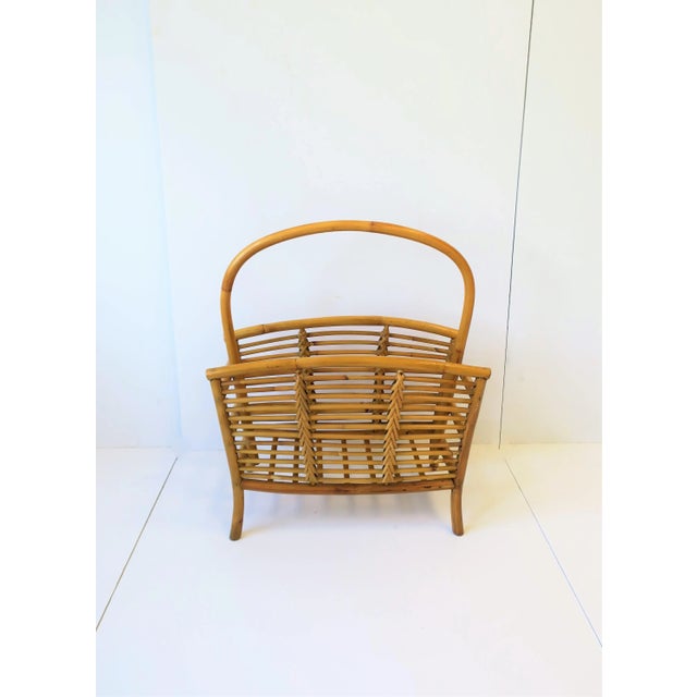 A vintage wicker, rattan, and bamboo magazine and book rack holder, circa late 20th century. Piece measures: 22.75 in. H...