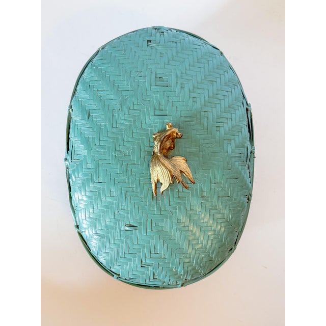 Incredible lacquered teal woven box with lid and a beautiful solid brass koi fish finial knob. Sourced from the Dallas...