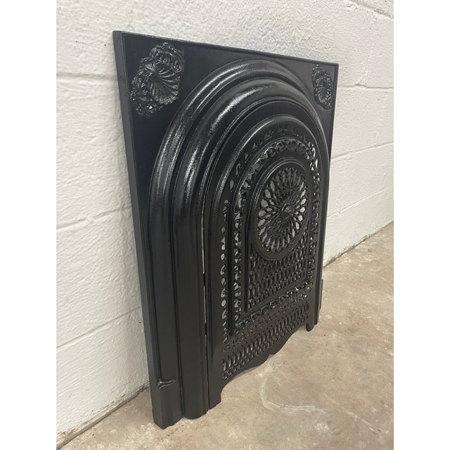 A remarkable piece of Southern architectural history, this late 19th-century cast iron fireplace surround and matching...