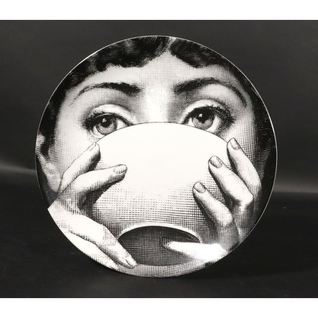 "The Silent Toast": Fornasetti "Themes & Variations" Plate #191 (Face with Bowl) A playful and graphic porcelain wall...