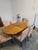 A charming vintage dining set featuring a solid oak oval extension table with a beautiful patterned top. The table rests...