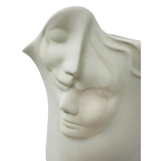 This striking 1996 studio art pottery face vase was designed by ceramic artist Sara Lund. The piece features a high-relief...