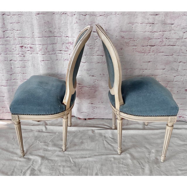 Set of Eight Louis XVI Style Painted Dining Chairs. Chairs feature the iconic oval medallion backs with cream painted...