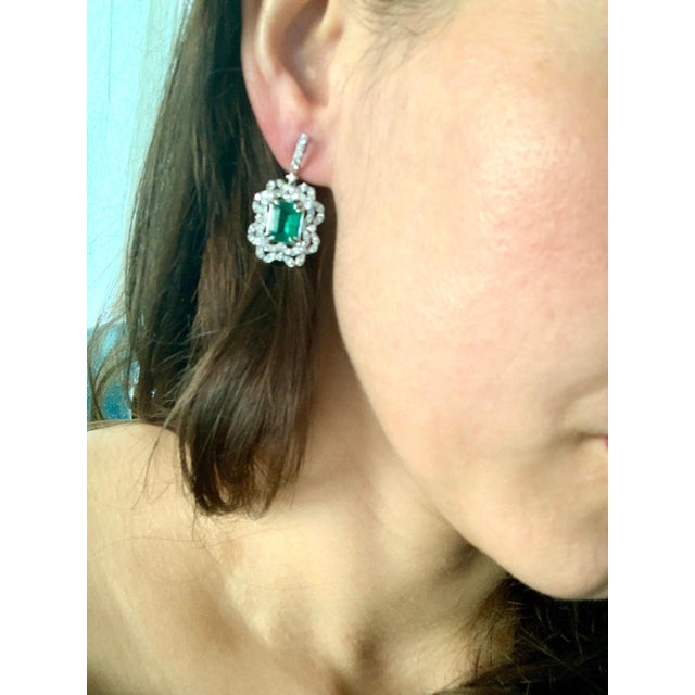 7 Carat Colombian Emerald Cut Emerald Diamond Hanging Earrings 18 K White Gold This exquisite pair of earrings are...