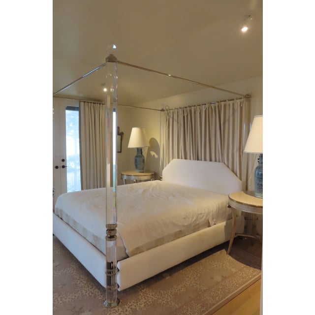 A beautiful King size four post bed frame with a soft white fabric head board and matching skirt. Striped fabric hanging...