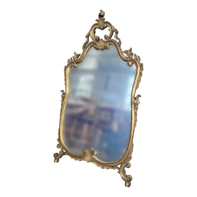 Elegant Venetian mirror with finely carved and gilded wooden frame. Dimensions (LxH) cm 63 x 110