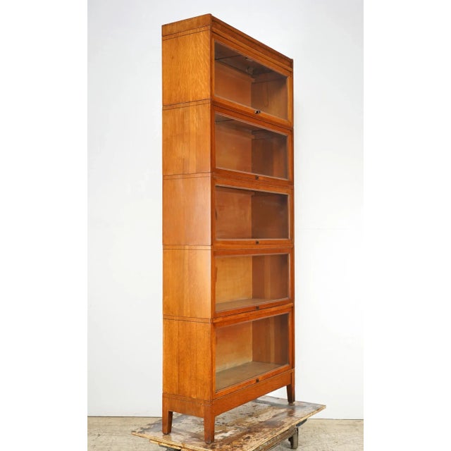 Antique five section oak wood barrister bookcase with original black finish steel knobs. Barrister bookcases were...