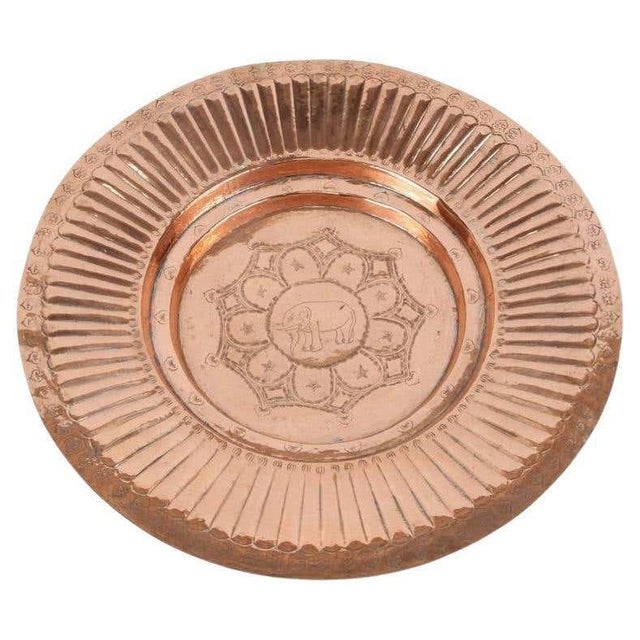 A handsome vintage Asian hand-hammered copper tray, dating to approximately the 1940s, distinguished by its warm polished...