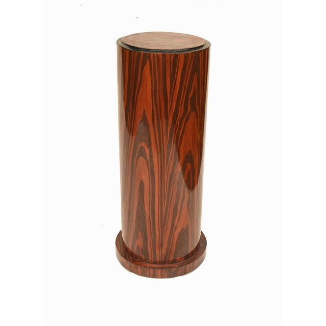 Striking pair of Art Deco style cylindrical pedestal stands veneered in richly figured Macassar ebony, the dramatic...