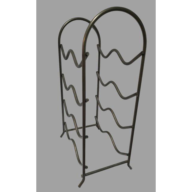 Add a touch of modern elegance to your home with this handmade wavy metal wine rack. With a capacity of 8 bottles, this...