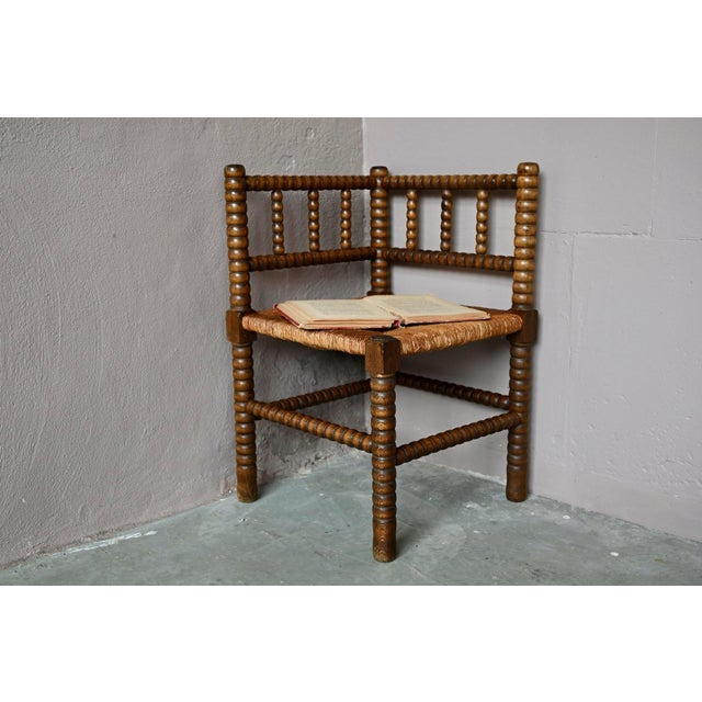 Simple yet charming, this small corner chair, known as a "fireside chair," evokes evenings spent by the fireplace,...