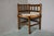 Simple yet charming, this small corner chair, known as a "fireside chair," evokes evenings spent by the fireplace,...