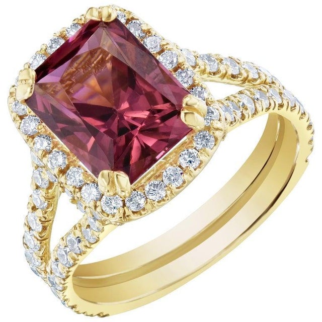 Stunning Dark Pink Tourmaline and Diamonds set in a spit-shank and halo setting. This ring has a 2.97 carat Rectangle Cut...