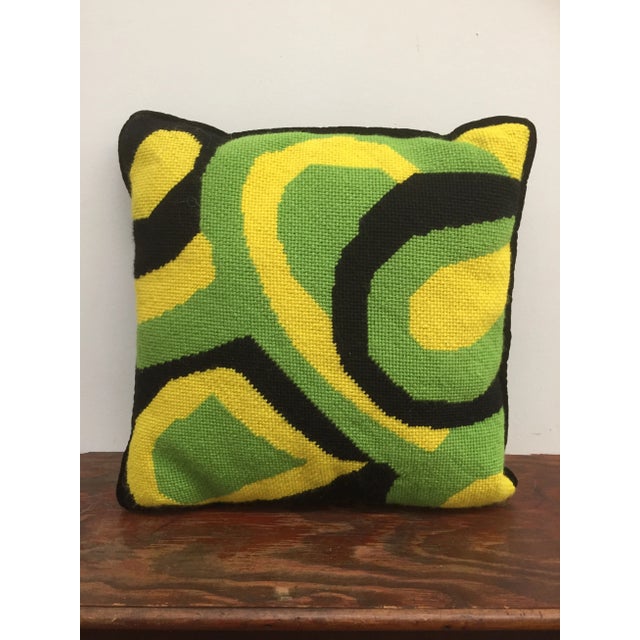 Wool and velvet pillow with colorful green, yellow and black embroidery.