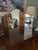 Vintage 1980s trifold mirror that sits on top of a vanity or desk with hinges and a wooden back