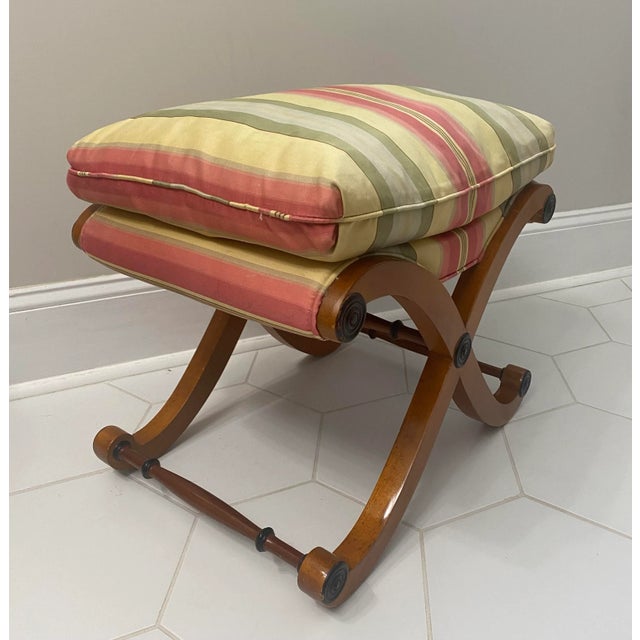 Beautiful scrolled x base ottoman bench with parsons style striped pastel down cushion top.