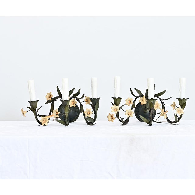 Italian vintage pair of floral-themed tôle wall sconces sprouting wild vines of sharp leaves and pale yellow flowers lit...