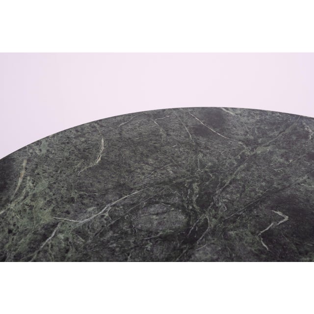 Stunning Green Marble dining table comes with a Black Cast Iron base, chrome tube upright and a nice thin round Marble top.