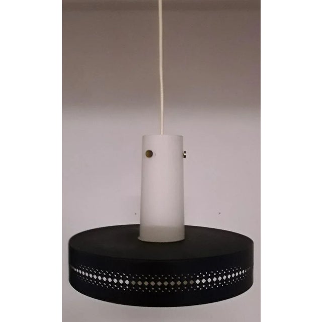 Vintage ceiling lamp with a dark blue, perforated metal screen & a white glass shade with brass bracket from the 70s...