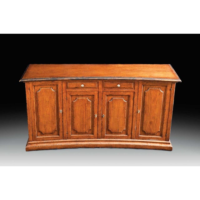 Handcrafted in Italy from solid walnut, this sideboard features a distinctive concave front, raised panel doors, and an...