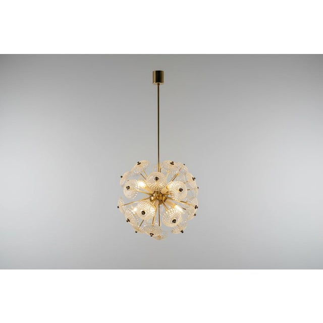 Mid-century chandelier with a dandelion-style composition, designed to create a diffused and reflective light effect...